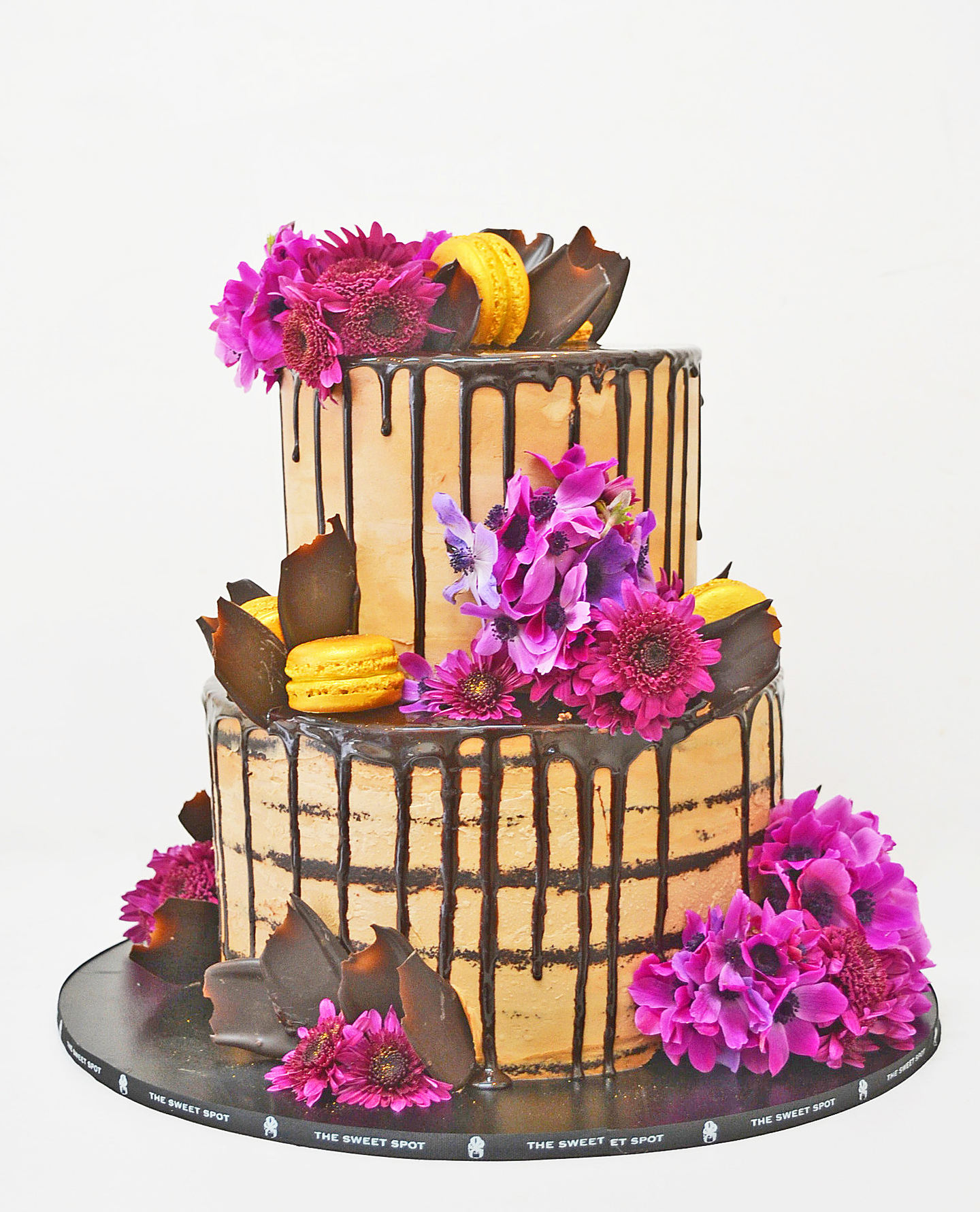 Photo 1 TIERED CHOCOLATE NAKED-DRIP CAKE WITH PURPLE FLOWERS AND MACARONS