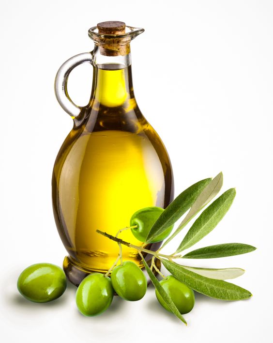 Branch with olives and a bottle of olive oil isolated on white