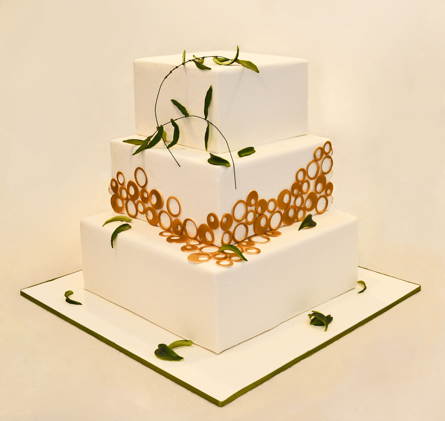 WEDDING CAKE WITH OLIVE BRANCHES AND GOLD CIRCLES